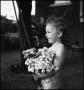 Photograph: [Portrait of a little girl holding a bouquet of flowers, 2]