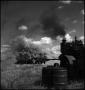 Photograph: [Engine billowing smoke while powering a thresher]