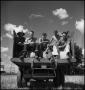 Photograph: [Five young men sitting on a truck bed]