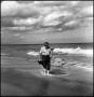 Photograph: [Joe Clark walking along the beach, 2]