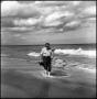 Photograph: [Joe Clark walking along the beach]