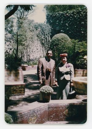 Primary view of object titled '[Frank Cuellar Sr. and Julia standing at a park]'.
