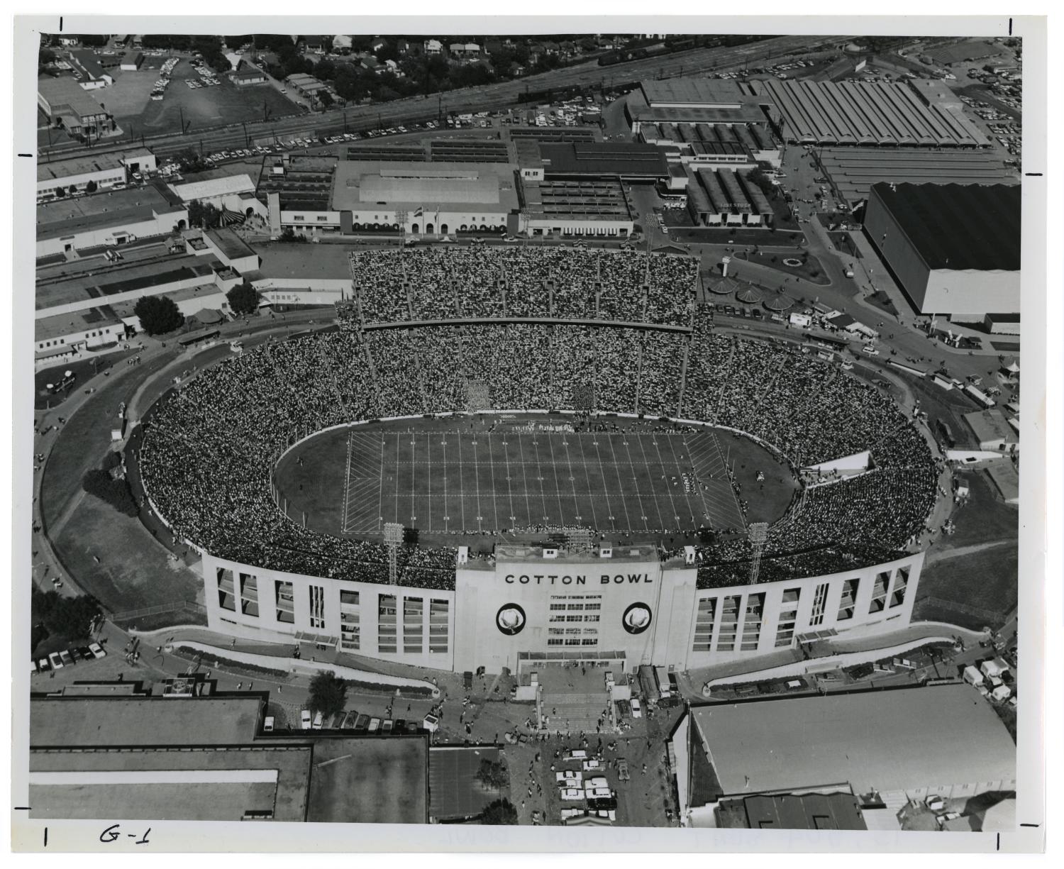 [Aerial view of the Cotton Bowl full of spectators] The Portal to