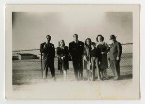 Primary view of object titled '[Several people in front of fence]'.