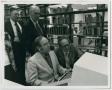 Photograph: [Four men viewing a computer monitor in Willis Library]