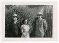 Thumbnail image of item number 1 in: '[Macario Cuellar, Mary Cuellar, and Frank Cuellar Sr. standing in front of a house]'.