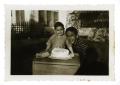 Photograph: [Bob Cuellar and Frank Cuellar Jr. with cake]
