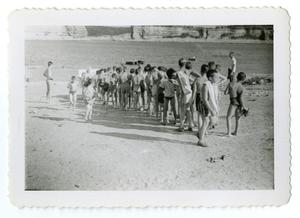 Primary view of object titled '[Bob Cuellar and other boys in forming a line in front of a lake]'.
