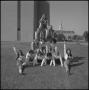 Photograph: [Cheerleaders pose in pyramid]