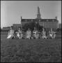 Photograph: Cheerleaders sitting in front of the Administration Building