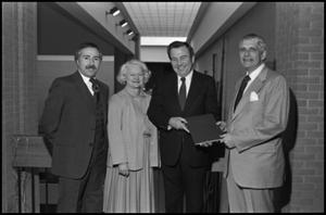 Primary view of object titled '[Texas Senator Oscar Mauzy awarding the 500th volume of the Oral History Collection]'.