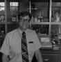 Photograph: [Man in front of lab equipment]