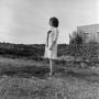 Photograph: [Patsy Gray Cloud standing in front of a rock wall]