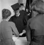 Photograph: [Graduate receiving commencement ceremony information 1962]