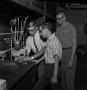 Photograph: [Three students in the Chemistry lab]