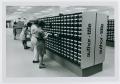 Photograph: [Four individuals looking through the card catalogs]