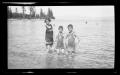 Photograph: [Irene, John, and Byrd Williams, III, standing in a lake]