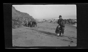 Primary view of object titled '[Irene Williams with her son Charles on a beach]'.