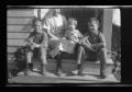 Primary view of [Irene Williams sitting on a porch with her sons]