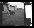 Thumbnail image of item number 1 in: '[Pam Williams sitting near a house with Angus]'.