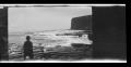 Photograph: [A boy standing near the ocean, looking toward Point Fermin]