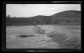 Primary view of [A spillway in front of a hillside]