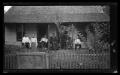 Photograph: [An unidentified family on their front porch]