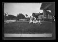 Thumbnail image of item number 1 in: '[Irene Williams sitting in her front yard with her sons John and Byrd III]'.
