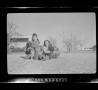 Photograph: [Pam and two other children with dogs]