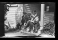 Primary view of [John, Byrd, Irene, and Charles Williams sitting on a porch]