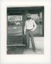 Photograph: [Photograph of man in front of a piano restoration building, 2]