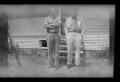 Primary view of [Byrd Williams Jr. standing outside with his son John]