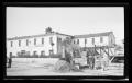 Primary view of [Man constructing a stone building in front of the Stevenson House in Monterey, California]