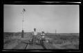 Primary view of [Two men on a rail cart]