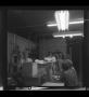 Photograph: [Underexposed photo of people working in a lab]