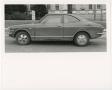 Photograph: [An 1970s Corolla parked outside dormitory]