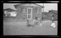 Primary view of [Irene, Byrd, John, and Charles Williams sitting in front of their house]