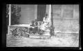 Photograph: [Irene Biffle Williams sitting on a porch with her sons]