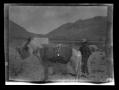 Photograph: [A man standing next to a donkey]