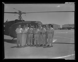 Primary view of object titled '[Crew of YH-70 #7 standing with Army personnel in front of helicopter]'.