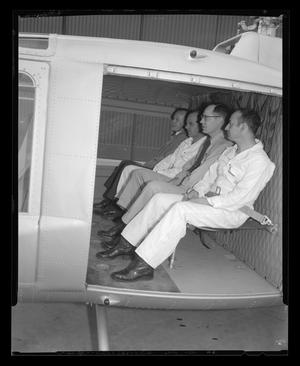 Primary view of object titled '[Service men seated in the cabin of the YH-40]'.