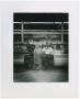 Photograph: [Bette Surzyszowsui Standing in a Factory]