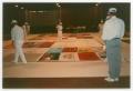 Photograph: [Members Prepare and Examine AIDS Memorial Quilt Panels]
