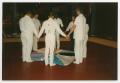 Photograph: [Members Form a Circle Around One AIDS Memorial Quilt]