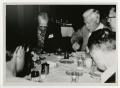 Photograph: [Men Sitting at a Table Having Dinner]