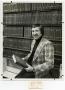 Primary view of [Ronald Marcello smiling with a book]