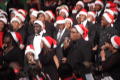 Photograph: [Blurry photo of a choir standing in rows, singing]