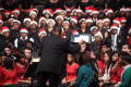 Photograph: [Conductor directing a band while a choir sits behind them, 3]