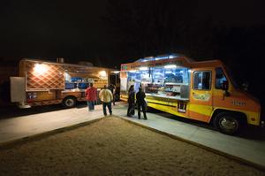 Primary view of object titled '[Food trucks parked behind the Eastside Social Club]'.