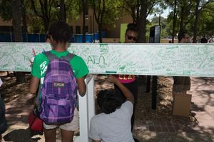 Primary view of object titled '[Students sign a steel beam at the UNT University Union]'.